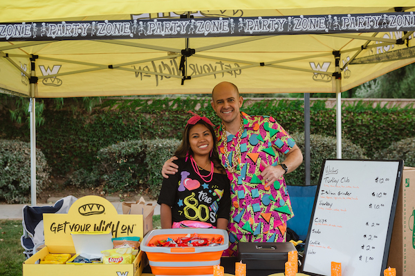 Two vendors standing behind a table