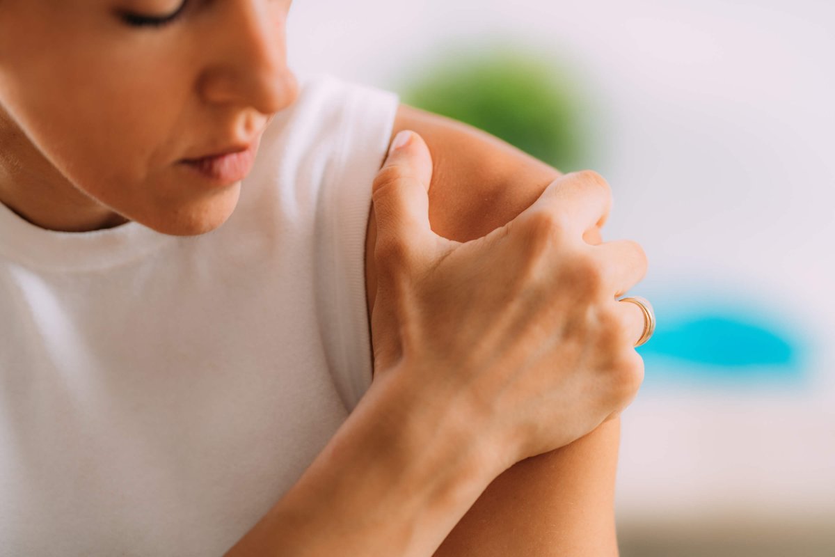 Person massaging their injured shoulder.